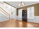 Open living space with hardwood floors and a two-story ceiling and staircase at 7003 Dacian Ln, Indian Trail, NC 28079