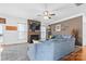 Cozy living room featuring a fireplace, a large sectional couch and a ceiling fan at 7003 Dacian Ln, Indian Trail, NC 28079