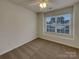 Neutral bedroom with carpet, a ceiling fan, and a large window offering natural light at 725 Rock Lake Gln, Fort Mill, SC 29715