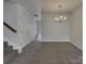 Neutral dining area with carpet and chandelier located by stairs at 725 Rock Lake Gln, Fort Mill, SC 29715
