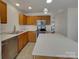 Well-lit kitchen featuring an island, stainless steel appliances, and wood cabinets at 725 Rock Lake Gln, Fort Mill, SC 29715
