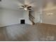 Spacious carpeted living room features a fireplace, ceiling fan and neutral color palette at 725 Rock Lake Gln, Fort Mill, SC 29715