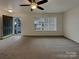 Inviting living room features neutral carpets, a front door and large window at 725 Rock Lake Gln, Fort Mill, SC 29715