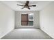 Bedroom featuring a ceiling fan, neutral walls, and a large window at 7340 Winery Ln, Charlotte, NC 28227