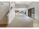 Inviting living room features a soaring ceiling, large windows, and sliding glass doors leading to an outdoor space at 7340 Winery Ln, Charlotte, NC 28227