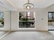 Cozy living room with a large window overlooking a green landscape and a mirrored wall for added depth at 7340 Winery Ln, Charlotte, NC 28227