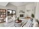 Bright living room with high ceilings, a white brick fireplace, and a sliding door to the outside at 7340 Winery Ln, Charlotte, NC 28227
