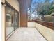Private outdoor patio featuring tile flooring, a sliding glass door, and mature landscaping at 7340 Winery Ln, Charlotte, NC 28227