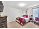 Bedroom featuring a cozy bed with red accents and a chest of drawers at 7623 E Lane Dr, Charlotte, NC 28212