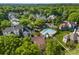 Community aerial view showcasing mature trees, a sparkling pool, and well-kept residential buildings at 766 Marsh Rd # Apt 2, Charlotte, NC 28209