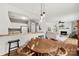 Cozy dining area with stylish pendant lighting near the open concept living room with a fireplace at 766 Marsh Rd # Apt 2, Charlotte, NC 28209