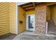 Charming entrance with yellow siding, brick accent, and stairs to the unit at 766 Marsh Rd # Apt 2, Charlotte, NC 28209