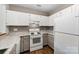 Kitchen featuring white cabinets, laminate countertops, and white appliances at 766 Marsh Rd # Apt 2, Charlotte, NC 28209