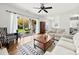 Bright living room featuring wood floors, a ceiling fan, and sliding glass doors to a patio with an egg swing chair at 766 Marsh Rd # Apt 2, Charlotte, NC 28209