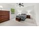 Spacious main bedroom with ceiling fan, carpet floors, and two bedside tables at 766 Marsh Rd # Apt 2, Charlotte, NC 28209