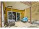 A cozy patio with hanging egg chair and outdoor seating. Sliding glass doors provide natural light at 766 Marsh Rd # Apt 2, Charlotte, NC 28209