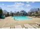 Community pool surrounded by lounge chairs and greenery, offering a relaxing outdoor space at 766 Marsh Rd # Apt 2, Charlotte, NC 28209