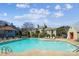 Community pool surrounded by lounge chairs, landscaping, and neighborhood homes in a gated area at 766 Marsh Rd # Apt 2, Charlotte, NC 28209