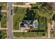 Aerial view of home showcasing a sparkling pool and lush green backyard with mature landscaping at 805 Hidden Pond Ln, Waxhaw, NC 28173