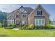 Beautiful brick home with well-maintained landscaping and traditional architectural details at 805 Hidden Pond Ln, Waxhaw, NC 28173