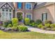 Charming home featuring manicured bushes lining the walkway to the front door at 805 Hidden Pond Ln, Waxhaw, NC 28173