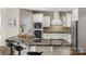 Bright kitchen featuring black marble countertops, white cabinets, and stainless steel appliances at 805 Hidden Pond Ln, Waxhaw, NC 28173