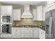 Modern kitchen design with white cabinets, stainless steel appliances, and tile backsplash at 805 Hidden Pond Ln, Waxhaw, NC 28173