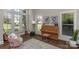 Cozy room with large windows, filled with natural light and a stylish piano at 805 Hidden Pond Ln, Waxhaw, NC 28173
