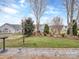 Serene backyard with landscaped garden beds and mature trees on a sunny day at 841 Platinum Dr, Fort Mill, SC 29708