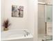 Bright bathroom features a soaking tub with chrome fixtures and a glass enclosed shower at 841 Platinum Dr, Fort Mill, SC 29708