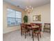 Dining room with a round wooden table, chandelier, and a large window at 841 Platinum Dr, Fort Mill, SC 29708