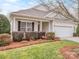 Landscaped front yard of home with trimmed bushes and green grass leading to a columned front porch at 841 Platinum Dr, Fort Mill, SC 29708