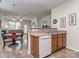 Eat-in kitchen area with oak cabinets, breakfast bar, and dining table at 841 Platinum Dr, Fort Mill, SC 29708