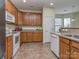 Traditional-style kitchen featuring wooden cabinets, white appliances, and neutral countertops at 841 Platinum Dr, Fort Mill, SC 29708