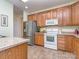 Well-lit kitchen featuring stainless steel appliances, wooden cabinets, and tile floors at 841 Platinum Dr, Fort Mill, SC 29708