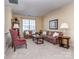 Comfortable living room featuring neutral walls, plush carpet, and classic furniture at 841 Platinum Dr, Fort Mill, SC 29708