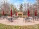 Outdoor fireplace with stone surround, seating, and tables for gatherings at 841 Platinum Dr, Fort Mill, SC 29708