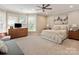 Bright bedroom featuring neutral carpet, lots of natural light, and updated ceiling fan at 875 Stratford Run Dr, Fort Mill, SC 29708