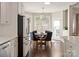 Bright breakfast nook featuring a round table, modern lighting, and expansive windows overlooking a lush landscape at 875 Stratford Run Dr, Fort Mill, SC 29708