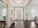 Bright foyer featuring dark wood floors, a white front door, and ample natural light at 875 Stratford Run Dr, Fort Mill, SC 29708