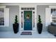 Stylish front door featuring a wreath, potted topiaries, and decorative accents at 875 Stratford Run Dr, Fort Mill, SC 29708
