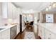 Spacious eat-in kitchen with white cabinets, stainless appliances, and dark hardwood floors at 875 Stratford Run Dr, Fort Mill, SC 29708