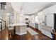 Well-appointed kitchen featuring white cabinets, a large island, and modern stainless steel appliances at 875 Stratford Run Dr, Fort Mill, SC 29708