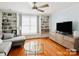 Cozy living room featuring hardwood floors, built-in shelving, and recessed lighting at 875 Stratford Run Dr, Fort Mill, SC 29708