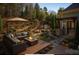 Inviting outdoor patio featuring a fire pit, built-in seating, grill, and lush landscaping perfect for entertaining at 875 Stratford Run Dr, Fort Mill, SC 29708