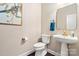Charming powder room featuring elegant wallpaper, a pedestal sink, and gold accents at 875 Stratford Run Dr, Fort Mill, SC 29708