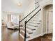 Elegant staircase with black railings, hardwood steps, and views of the living room at 875 Stratford Run Dr, Fort Mill, SC 29708