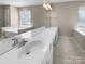 Bathroom features double sinks, tiled floor, tub, and bright windows with natural light at 9139 Hearst Ct, Charlotte, NC 28269