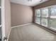 This bedroom features neutral walls and carpet, bright windows, and natural light at 9139 Hearst Ct, Charlotte, NC 28269