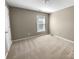 Neutral bedroom featuring carpet flooring, a window with blinds, and ample space at 9139 Hearst Ct, Charlotte, NC 28269